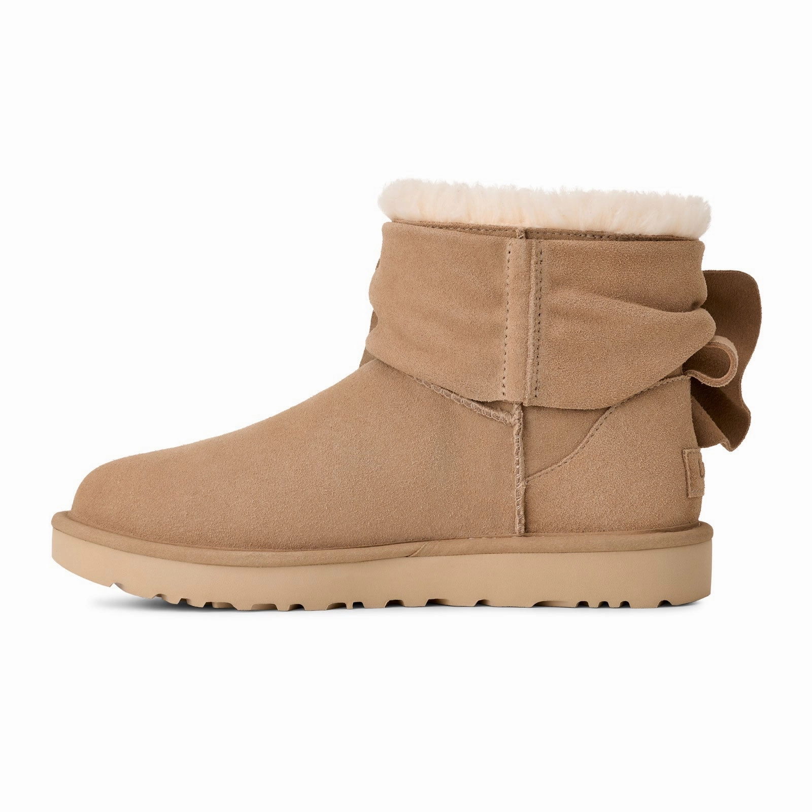 Clean Silhouette Slip Resistant Grip UGG? Classic Mini Bow (Women) - Sand